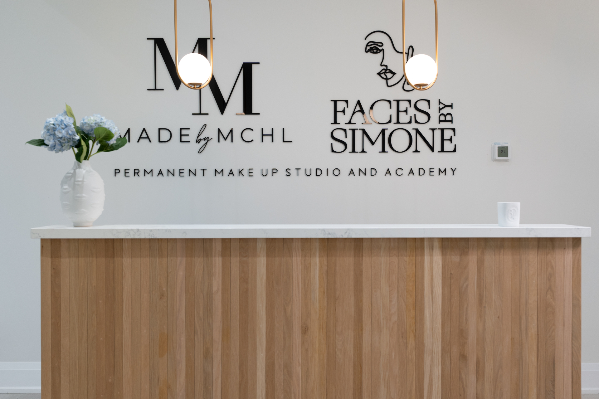 MADEBYMCHL reception desk and signage at the Vaughan permanent makeup studio
