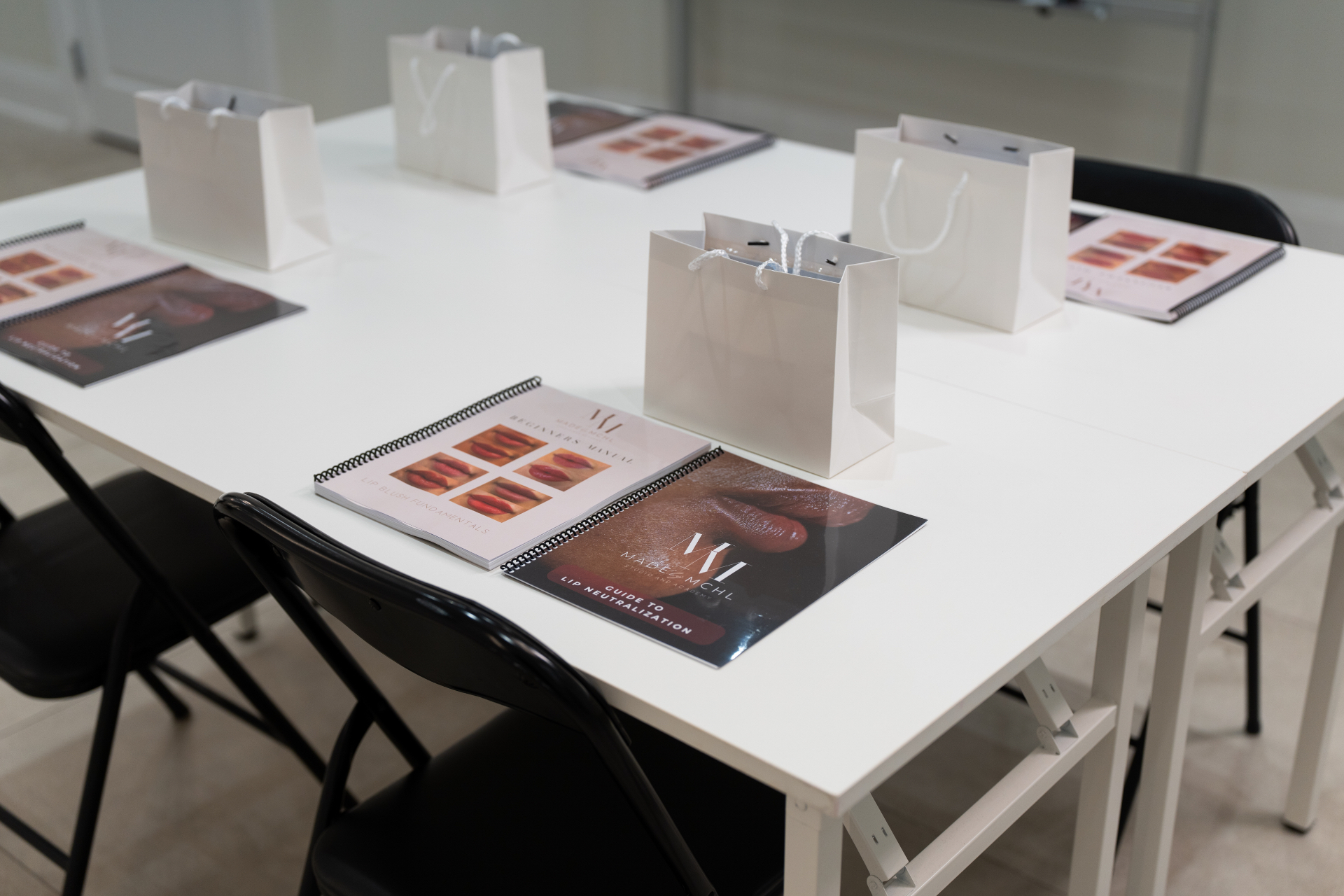 MADEBYMCHL student manuals and welcome kits set up in the academy classroom